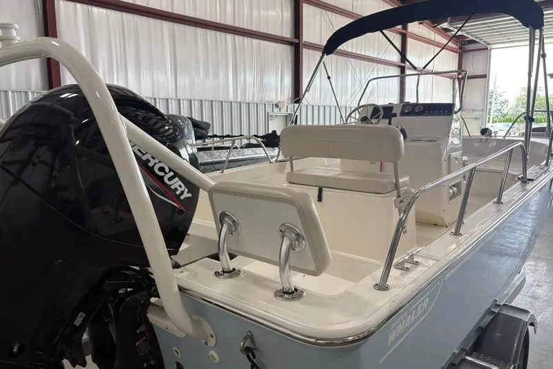 Slide: The Image of 2022 Boston Whaler 190 Montauk boat with Mercury engine in a storage facility. - 27