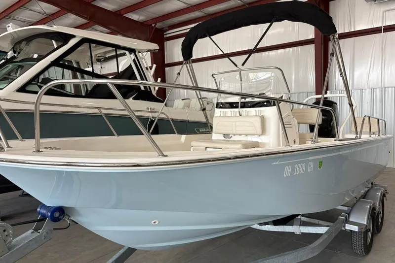Slide: The Image of 2022 Boston Whaler 190 Montauk boat in a showroom, featuring sleek design and modern amenities. - 24