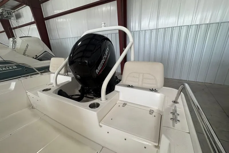 Slide: The Image of 2022 Boston Whaler 190 Montauk boat with Mercury engine in a storage facility. - 30