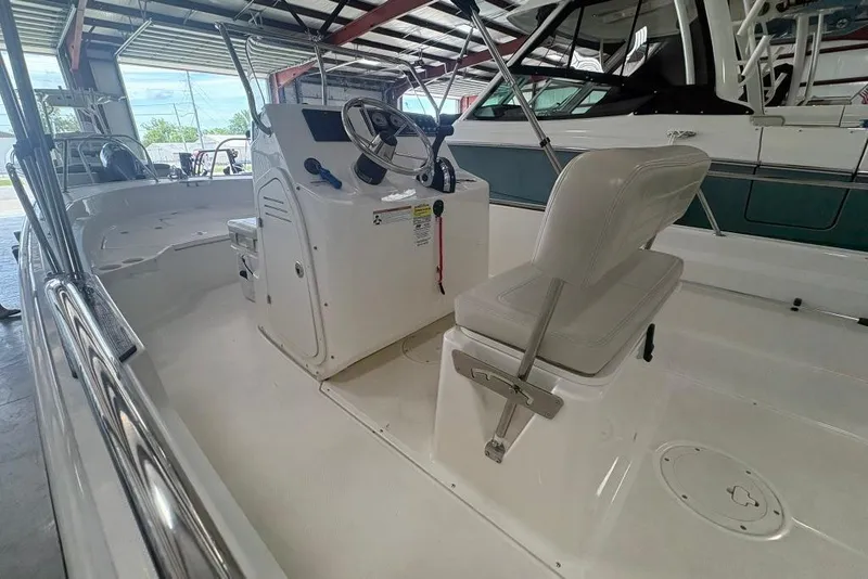 Slide: The Image of 2022 Boston Whaler 190 Montauk boat interior with steering console and seating. - 8