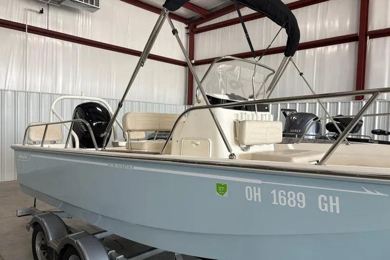 Slide: The Image of 2022 Boston Whaler 190 Montauk boat in a storage facility, side view. - 14