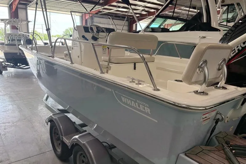 Slide: The Image of 2022 Boston Whaler 190 Montauk boat in a showroom, side view. - 25