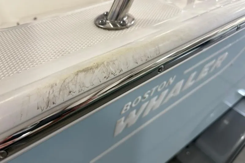 Slide: The Image of 2022 Boston Whaler 190 Montauk boat with visible scratches on the side. - 26