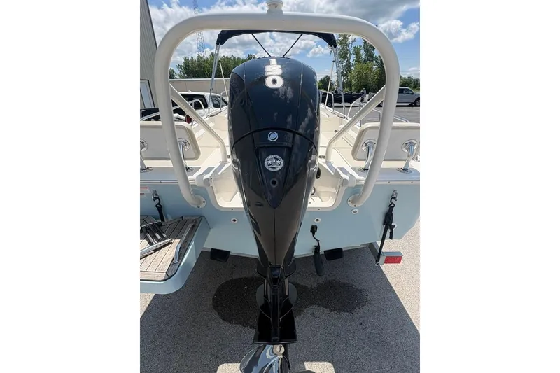 Slide: The Image of 2022 Boston Whaler 190 Montauk boat with powerful outboard motor, parked outdoors. - 7