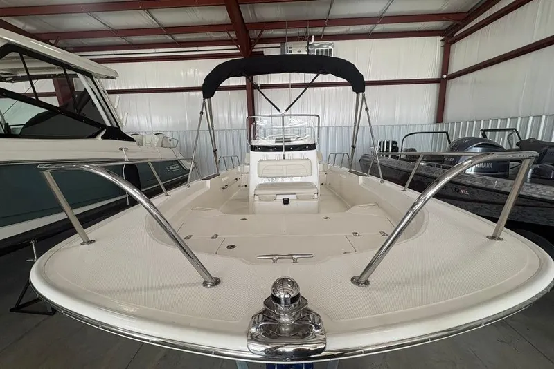 Slide: The Image of 2022 Boston Whaler 190 Montauk boat in storage, showcasing spacious deck and seating. - 23