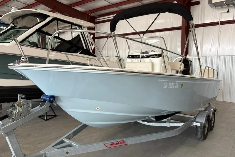 Slide: The Image of 2022 Boston Whaler 190 Montauk boat on trailer in indoor storage. - 20