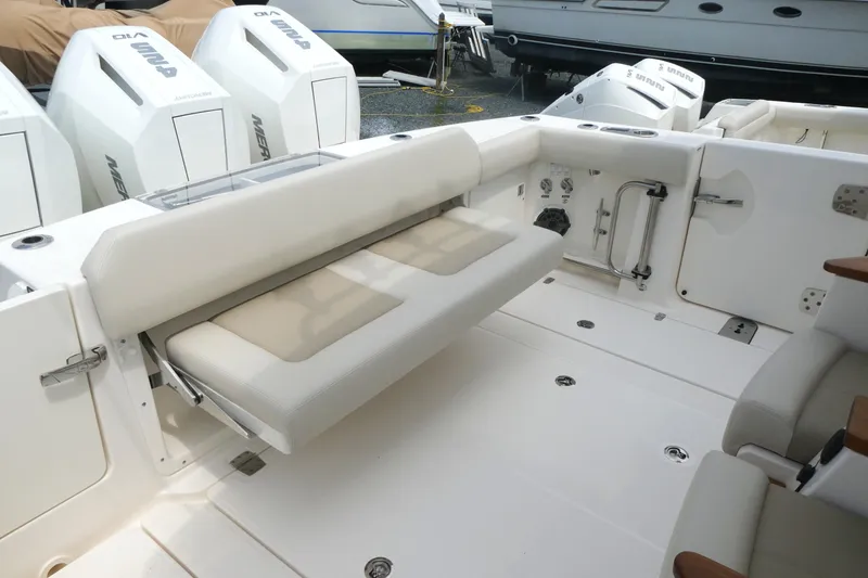 Slide: The Image of 2027 Boston Whaler 360 Outrage boat interior with foldable seating and powerful outboard engines. - 5