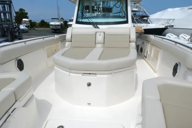 Slide: The Image of 2027 Boston Whaler 360 Outrage boat interior with beige seating and modern design. - 13