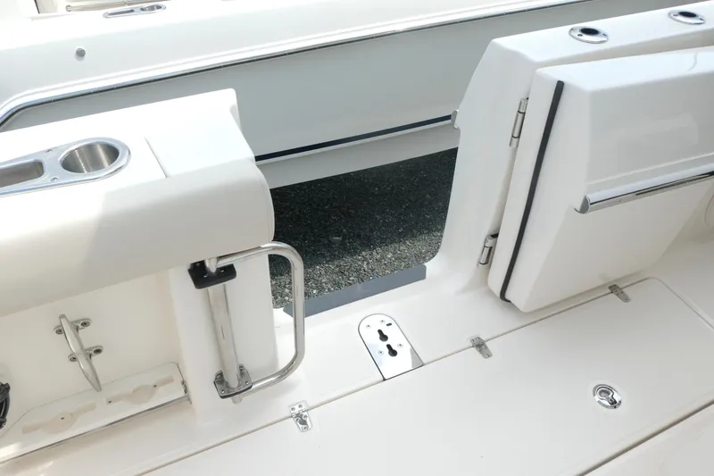 Slide: The Image of Boston Whaler 360 Outrage 2027 boat deck with open side door and stainless steel fixtures. - 11