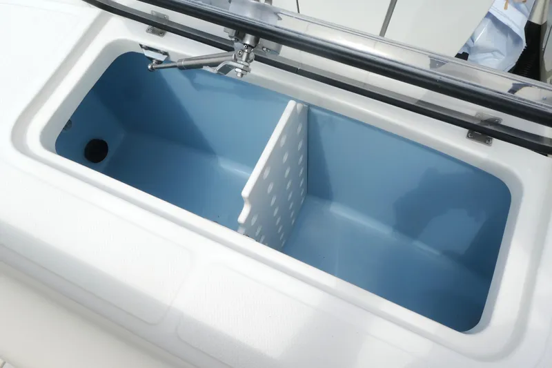 Slide: The Image of Open storage compartment on 2027 Boston Whaler 360 Outrage boat, featuring a blue interior. - 10