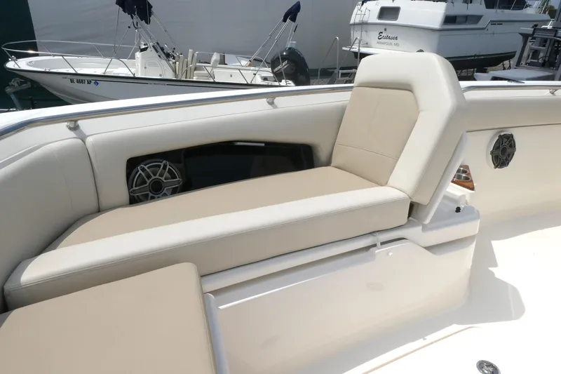 Slide: The Image of Luxurious seating on 2027 Boston Whaler 360 Outrage boat, featuring beige upholstery and speaker system. - 15