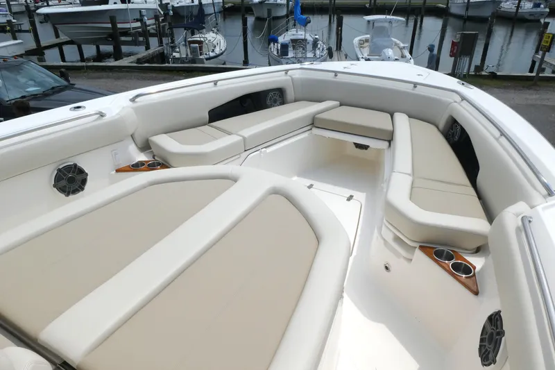 Slide: The Image of 2027 Boston Whaler 360 Outrage boat interior with spacious seating and cup holders. - 12