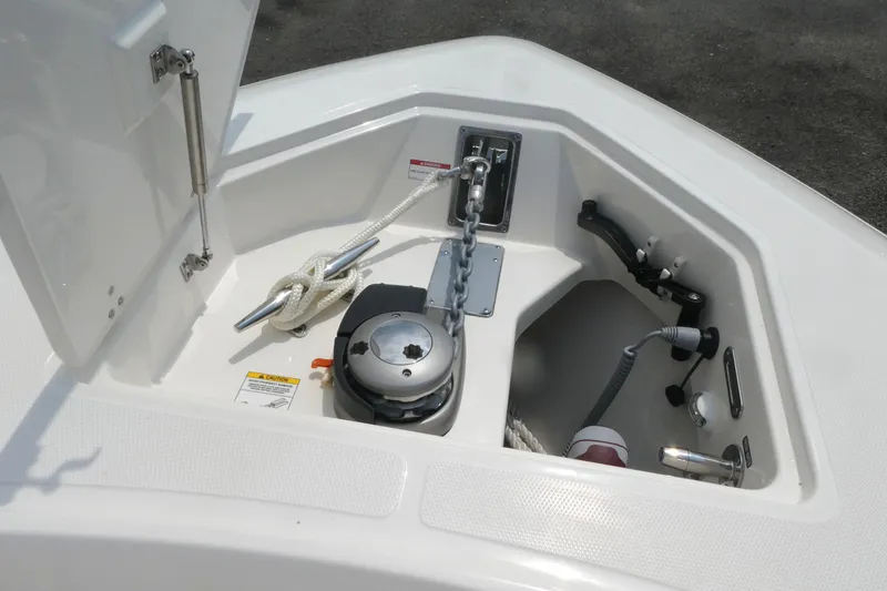 Slide: The Image of Anchor compartment of 2027 Boston Whaler 360 Outrage boat, featuring winch and rope storage. - 14