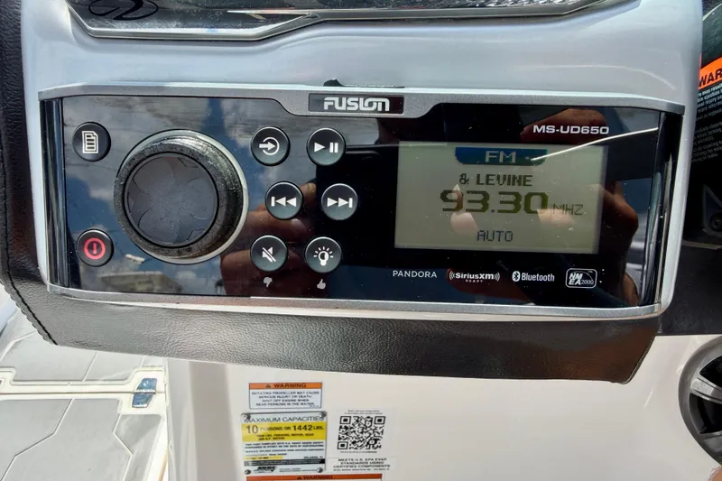 Slide: The Image of Fusion MS-UD650 stereo system on 2020 Regal 21 OBX boat dashboard, displaying FM 93.30 MHz. - 17