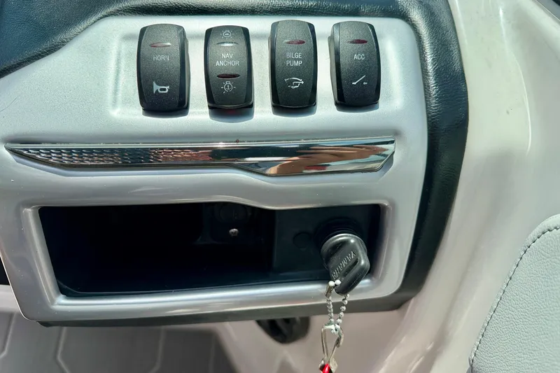 Slide: The Image of Control panel of a 2020 Regal 21 OBX boat with switches and ignition key. - 20