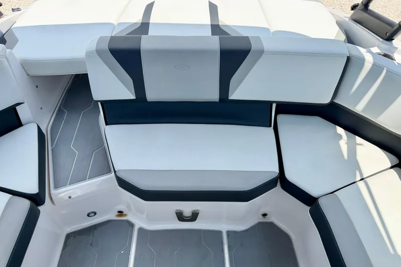 Slide: The Image of 2020 Regal 21 OBX boat interior with cushioned seating and sleek design. - 23