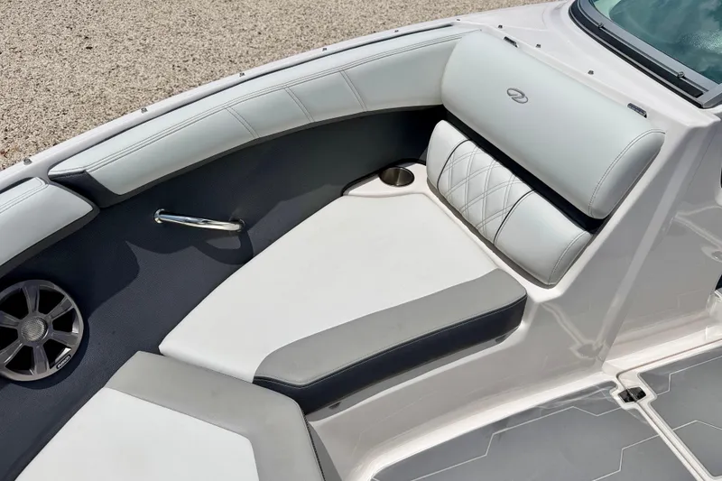 Slide: The Image of 2020 Regal 21 OBX boat interior with cushioned seating and speaker. - 10