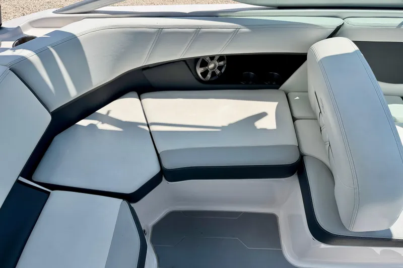 Slide: The Image of 2020 Regal 21 OBX boat interior with cushioned seating and speaker detail. - 22
