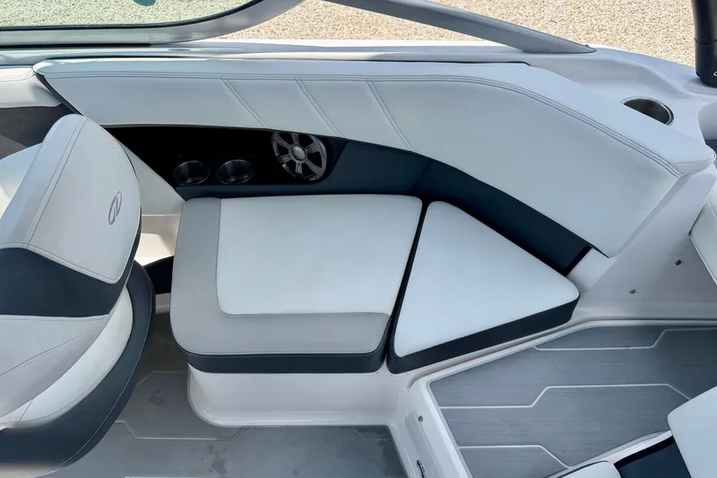 Slide: The Image of 2020 Regal 21 OBX boat interior with cushioned seating and cup holders. - 24