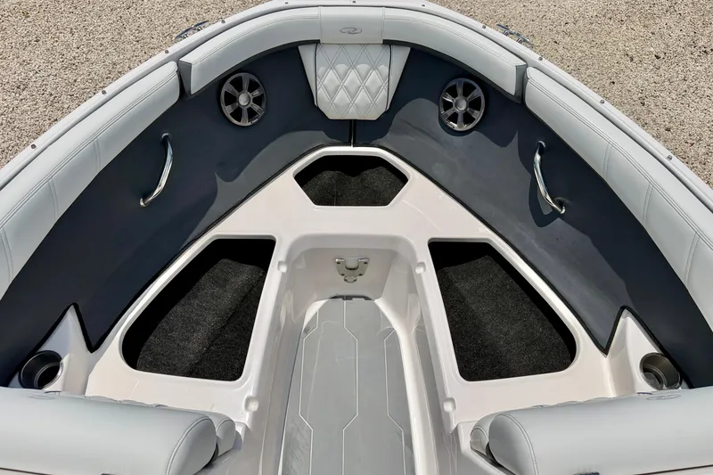 Slide: The Image of 2020 Regal 21 OBX boat interior with cushioned seating and storage compartments. - 27