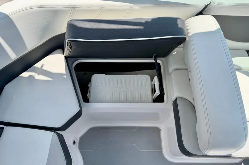 Slide: The Image of 2020 Regal 21 OBX boat interior with open storage compartment and cooler. - 29