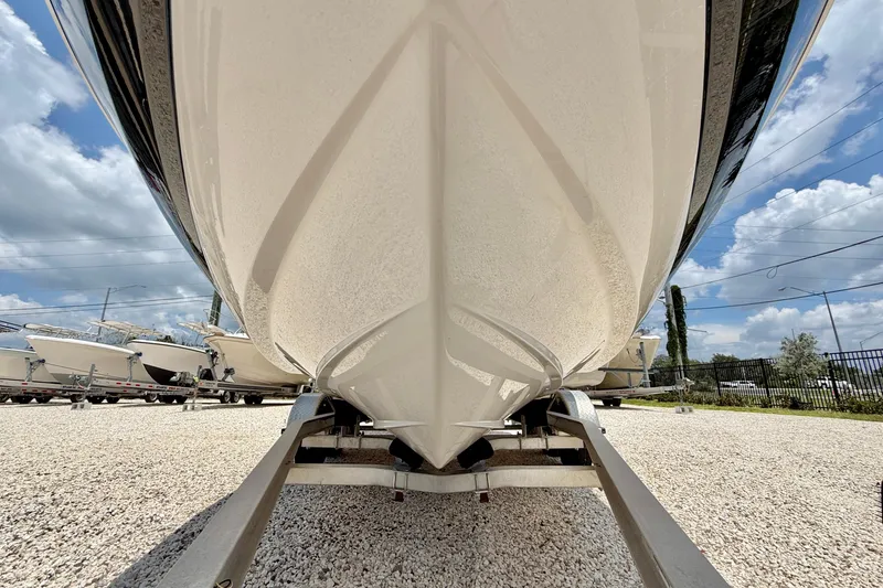 Slide: The Image of 2020 Regal 21 OBX boat on trailer, viewed from below, with clear sky background. - 26