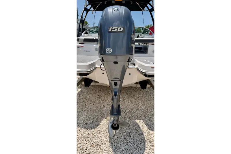 Slide: The Image of 2020 Regal 21 OBX boat with a 150 horsepower outboard motor, displayed on gravel. - 37