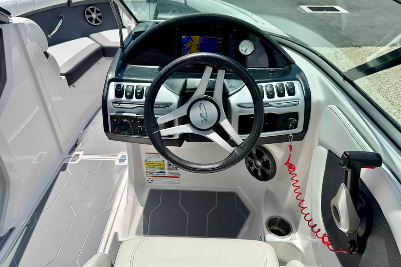 Slide: The Image of 2020 Regal 21 OBX boat cockpit with steering wheel and control panel. - 14