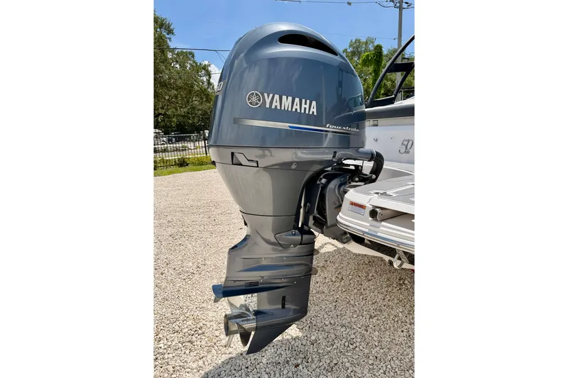 Slide: The Image of Yamaha outboard motor on 2020 Regal 21 OBX boat, parked on gravel. - 36
