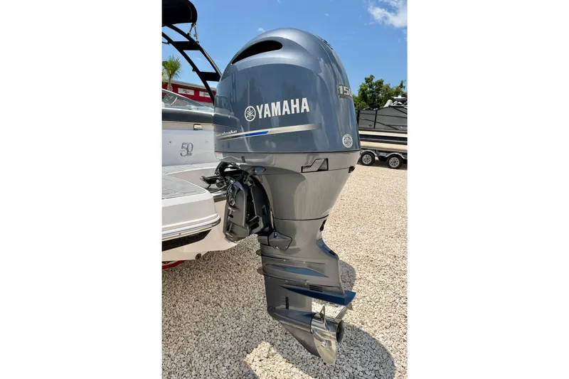 Slide: The Image of 2020 Regal 21 OBX with Yamaha outboard motor, parked on gravel under clear sky. - 38
