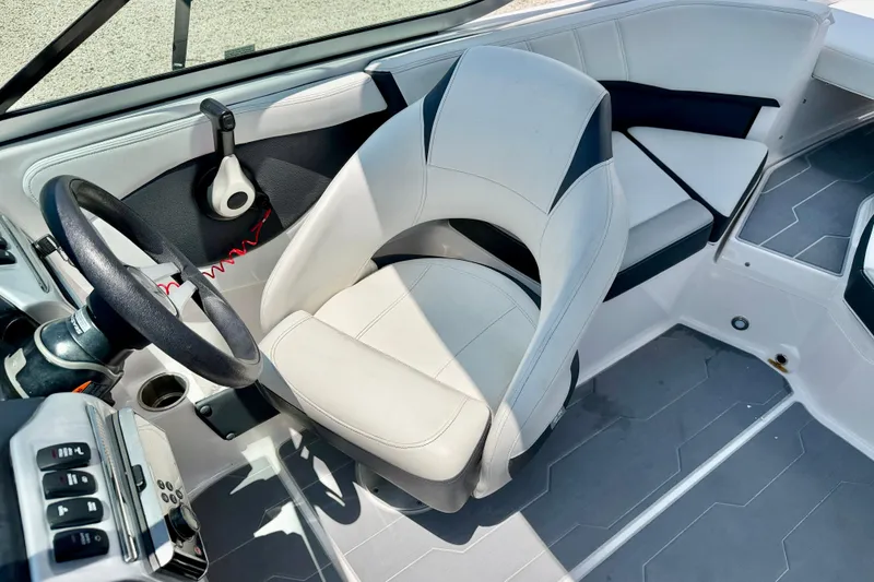 Slide: The Image of Interior of 2020 Regal 21 OBX boat featuring steering wheel and seating area. - 12