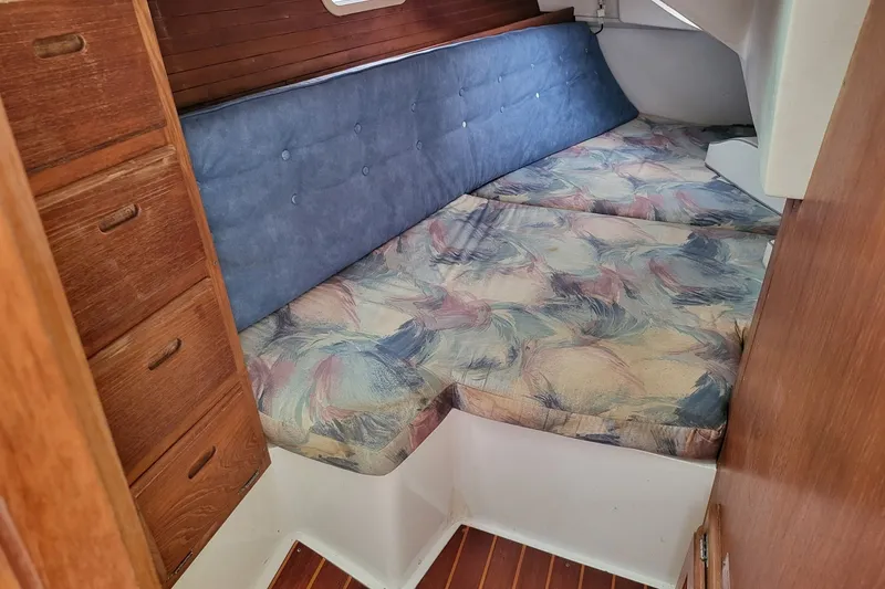 Slide: The Image of Cozy cabin interior of a 1997 Catalina 36 MkII sailboat with patterned cushions. - 6