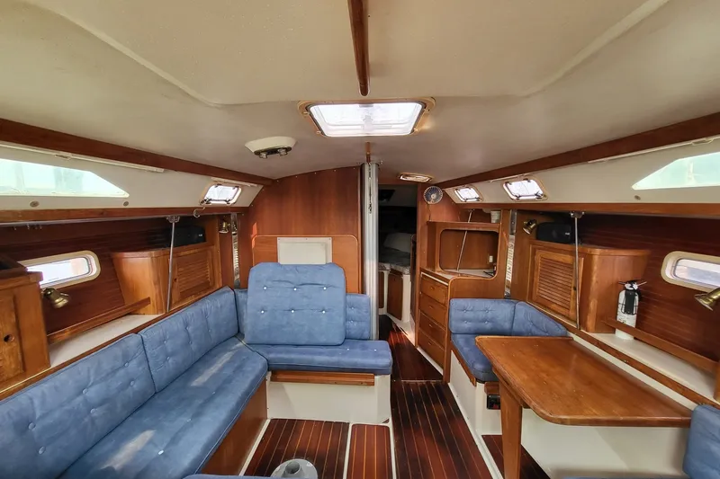 Slide: The Image of Interior of a 1997 Catalina 36 MkII sailboat with blue upholstery and wooden finishes. - 9