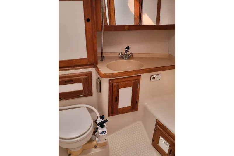 Slide: The Image of Bathroom interior of 1997 Catalina 36 MkII sailboat with wooden cabinetry and compact fixtures. - 4