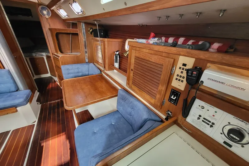 Slide: The Image of Interior of a 1997 Catalina 36 MkII sailboat with wood finish and blue seating. - 7