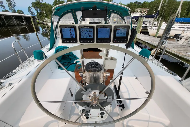 Slide: The Image of Cockpit of 1997 Catalina 36 MkII sailboat with navigation instruments and steering wheel. - 2