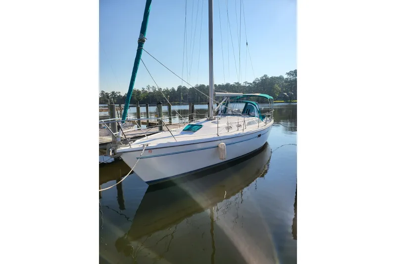 Slide: The Image of Sailboat Catalina 36 MkII 1997 docked on calm water, clear sky background. - 1