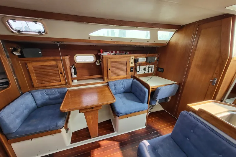 Slide: The Image of Interior of 1997 Catalina 36 MkII sailboat with wooden furnishings and blue seating. - 11