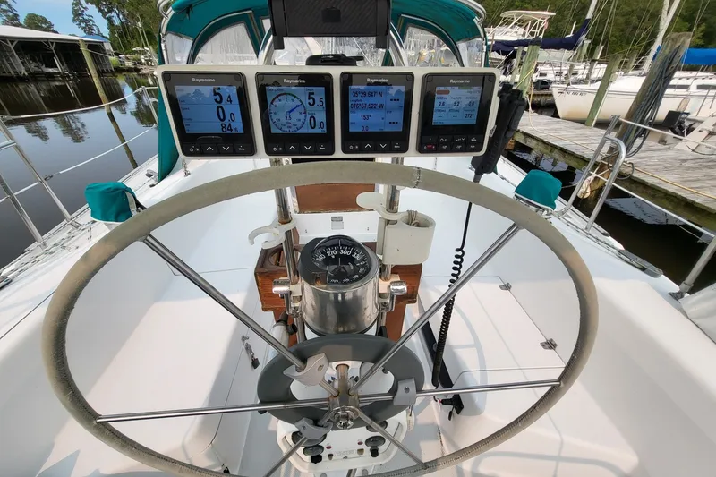Slide: The Image of Cockpit of 1997 Catalina 36 MkII sailboat with navigation instruments and steering wheel. - 15