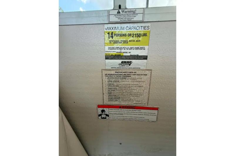 Slide: The Image of Warning label on 2009 Premier 240 SunSpree boat, indicating maximum capacity of 14 persons. - 11