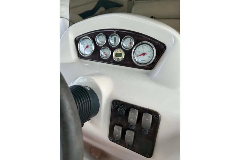 Slide: The Image of Dashboard of a 2009 Premier 240 SunSpree boat with gauges and switches. - 6