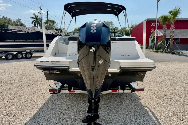 Slide: The Image of 2022 Sea Ray SPX 230 Outboard boat with powerful engine, parked on gravel lot. - 6