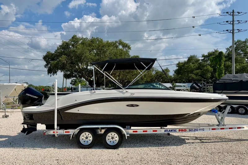 Slide: The Image of 2022 Sea Ray SPX 230 Outboard boat on trailer under blue sky. - 4