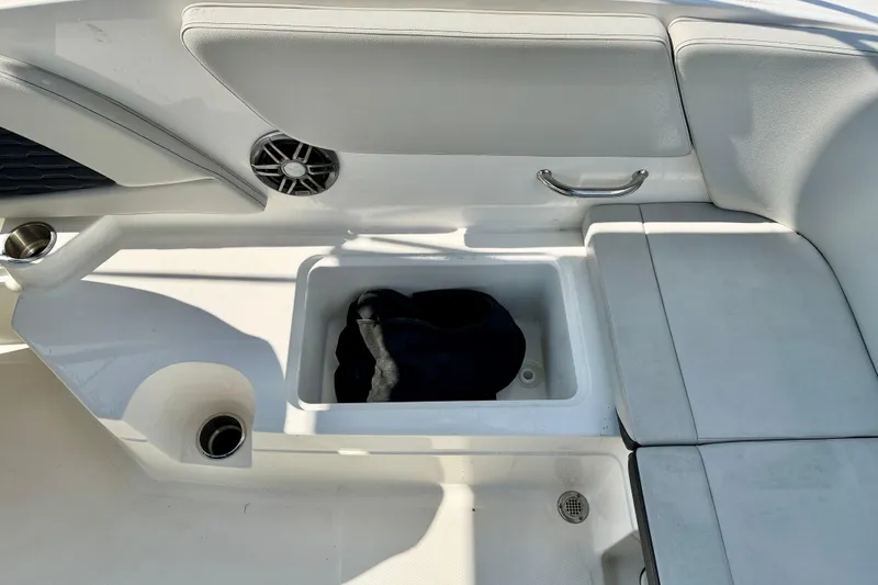 Slide: The Image of 2022 Sea Ray SPX 230 Outboard boat interior with storage compartment and seating. - 28