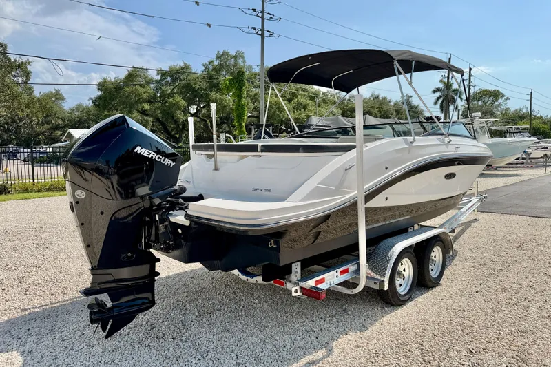 Slide: The Image of 2022 Sea Ray SPX 230 Outboard boat on trailer, featuring a Mercury engine. - 7