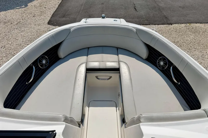 Slide: The Image of 2022 Sea Ray SPX 230 Outboard boat interior with cushioned seating and speakers. - 9