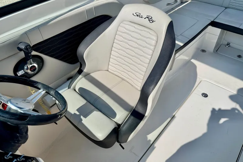Slide: The Image of 2022 Sea Ray SPX 230 Outboard boat interior with steering wheel and branded seat. - 12