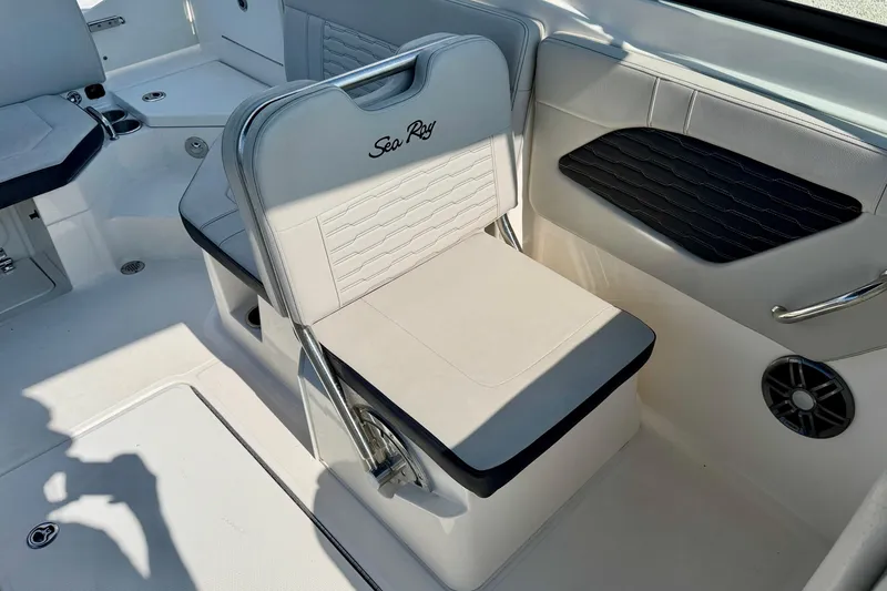 Slide: The Image of 2022 Sea Ray SPX 230 Outboard boat interior with white seating and modern design. - 21