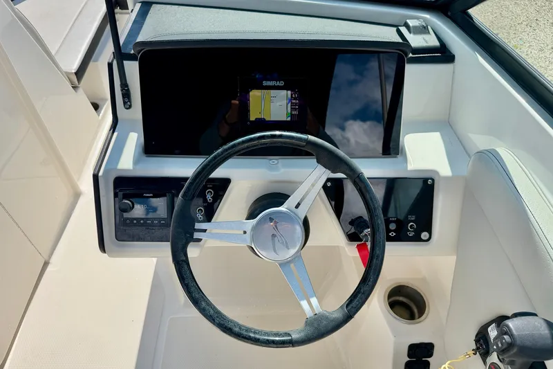 Slide: The Image of Steering console of 2022 Sea Ray SPX 230 Outboard with navigation display. - 14