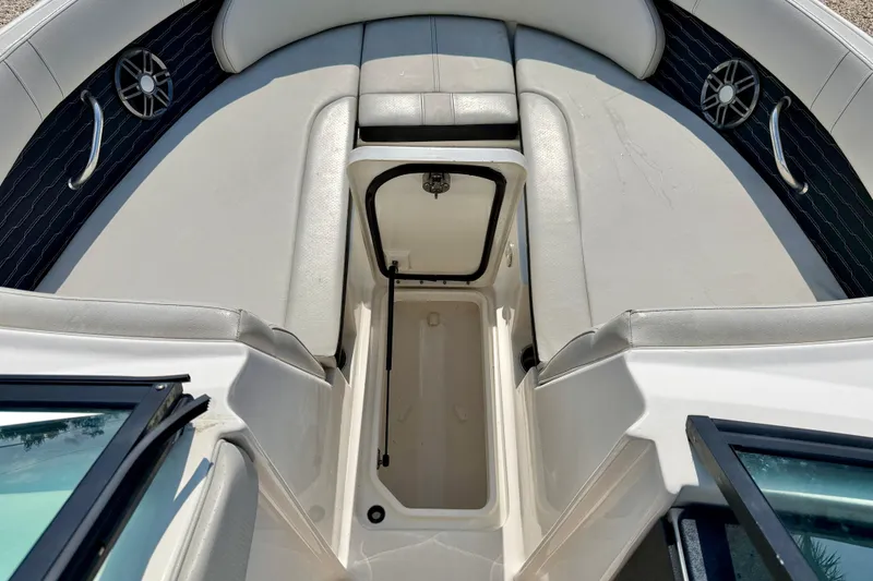 Slide: The Image of 2022 Sea Ray SPX 230 Outboard boat interior with open storage compartment. - 19